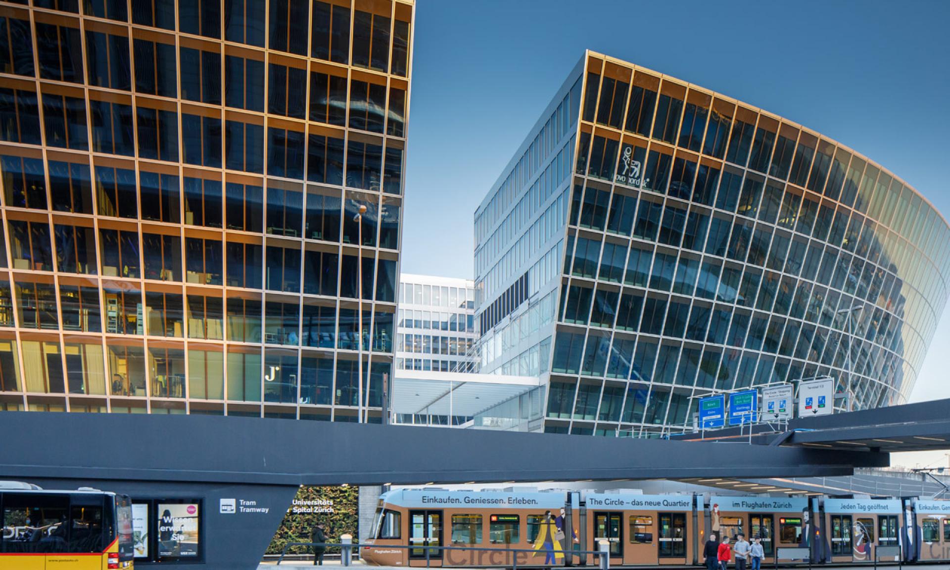 The Circle at Zurich Airport, modern glass buildings and tram station in daylight